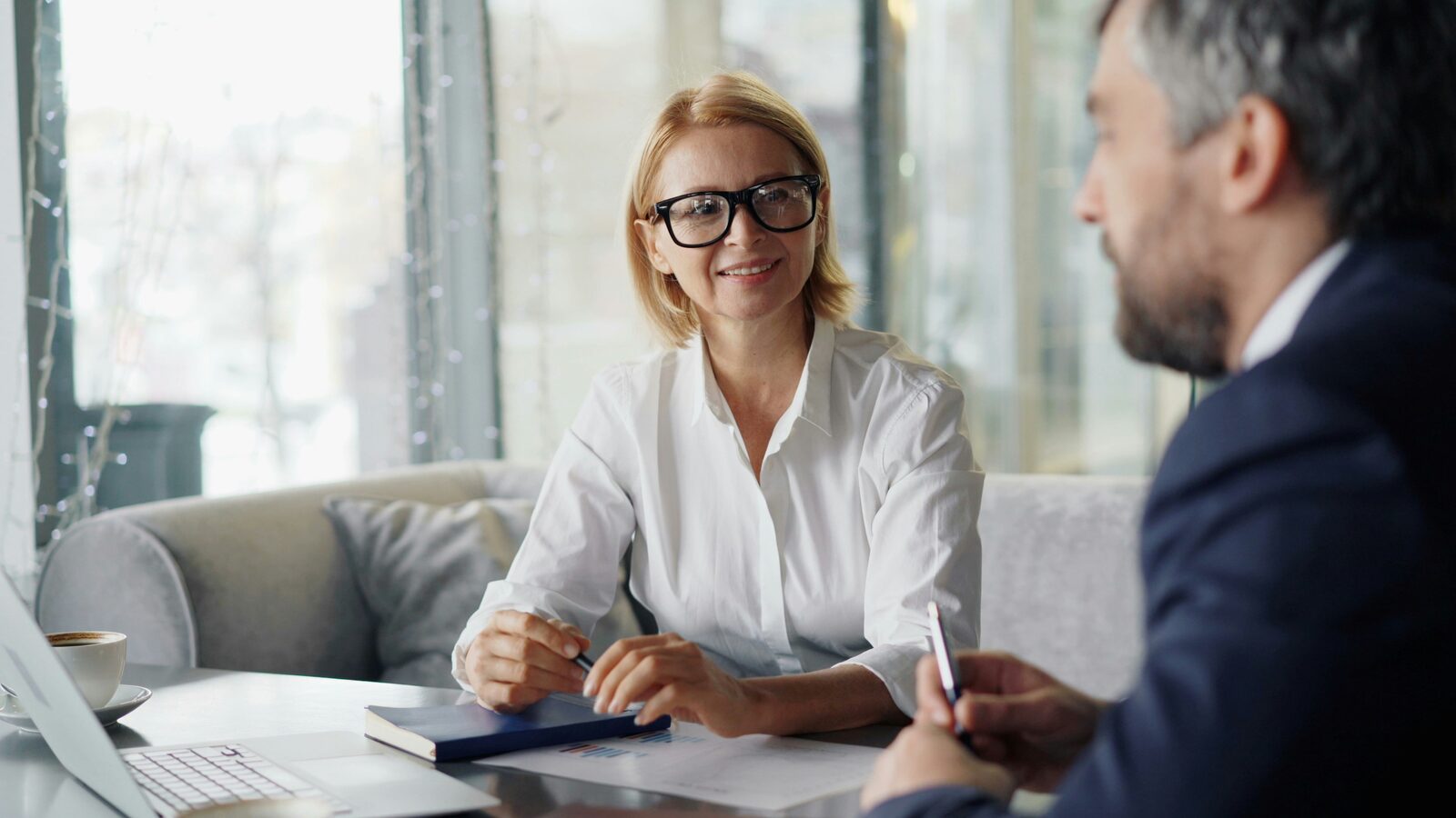 A senior adviser in discussion with a colleague